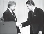  ?? AP ?? Jimmy Carter and Ronald Reagan shake hands on Oct. 28, 1980, in Cleveland before their debate.