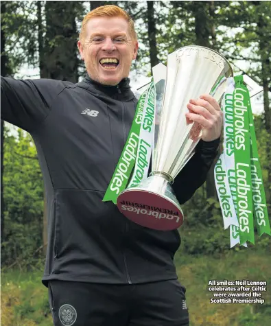  ??  ?? All smiles: Neil Lennon celebrates after Celtic were awarded the Scottish Premiershi­p