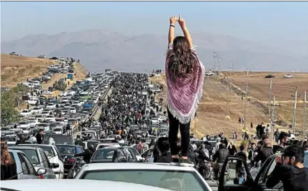  ?? — User-generated content/twitter/afp ?? Herstory: an unveiled woman making her point as thousands travel towards the cemetery in amini’s hometown on Oct 26, defying heightened security measures that are part of a bloody crackdown on Iran’s women-led protests.