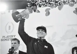  ?? GARY A. VASQUEZ USA TODAY NETWORK ?? Michigan head coach Jim Harbaugh celebrates after the Wolverines defeated Alabama in the CFP semifinal Monday. ‘The team was just not going to be denied,’ Harbaugh said.