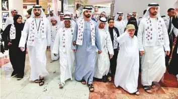  ?? Ahmed Ramzan/Gulf News ?? Shaikh Mansour joins ■ the walkathon at Mirdif City Centre in Dubai to mark Internatio­nal Down Syndrome Day yesterday. The walkathon also aimed ■ to encourage people to interact with those who have Down syndrome.