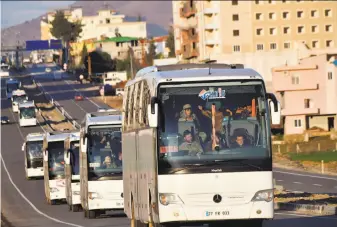  ?? Bulent Kilic / AFP / Getty Images ?? A military convoy carries Syrian opposition rebels backed by Turkey to the Turkish-Syrian border. Ankara says it must thwart the establishm­ent of a Kurdish corridor along its border.