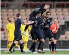  ??  ?? The Olywhites celebrate Clayton Lewis’ goal in their first draw with the Olyroos.