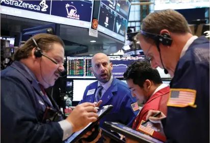  ?? (Brendan McDermid/Reuters) ?? TRADERS WORK on the floor of the New York Stock Exchange yesterday. The US stock market gained, lifted by defense and tech stocks, after US President Donald Trump announced arms deals of up to $350 billion with Saudi Arabia over the weekend.