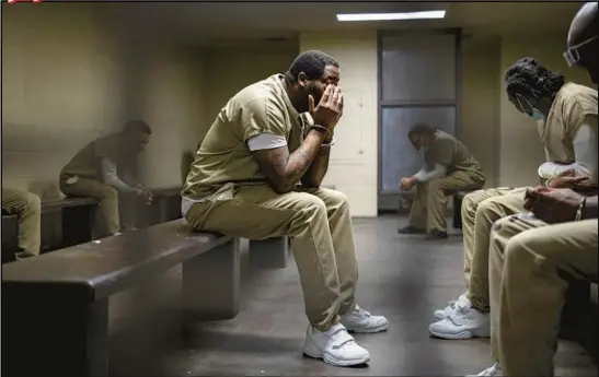  ?? ?? Above: Sitting in a holding cell at the Leighton Criminal Court Building in Chicago, Michael Laster waits for the 83rd court appearance in his case, held in October. Laster opted to cut a plea deal at his 86th appearance.