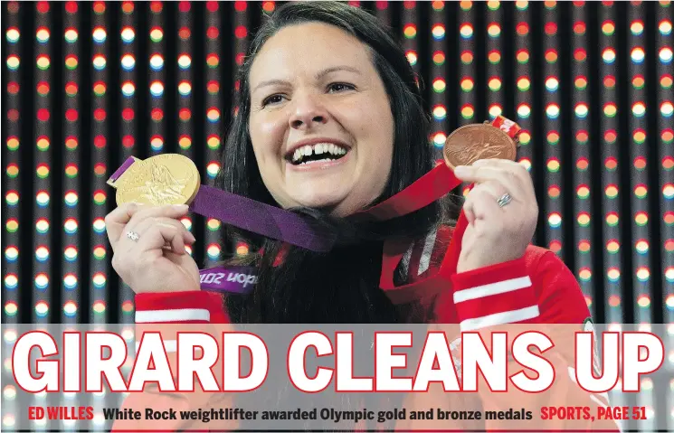  ?? —CP ?? Canadian weightlift­er and mother of three Christine Girard holds up the gold and bronze Olympic medals she was awarded during a ceremony Monday in Ottawa.