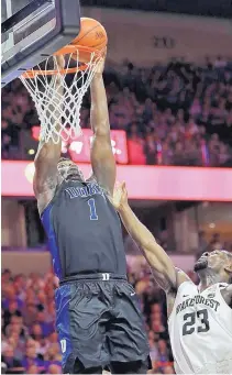  ?? CHUCK BURTON/ASSOCIATED PRESS ?? Duke’s Zion Williamson (1) goes up to dunk during the Blue Devils’ win over Chaundee Brown (23) and Wake Forest Tuesday.