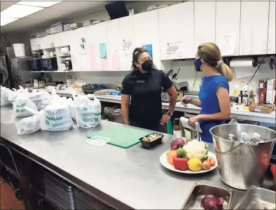  ?? Luther Turmelle / Hearst Connecticu­t Media ?? Beca Tuinei, left, and Lt. Gov. Susan Bysiewicz talk about the Women’s Business Developmen­t Council’s Equity Match grant program in Wallingfor­d. Tuinei’s business Nala’s Kitchen is a recipient of the grant program.