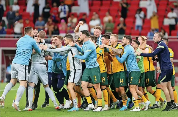  ?? ?? MISSION ACCOMPLISH­ED: Stoke City defender Harry Souttar joins his Australia team-mates to celebrate reaching the World Cup finals in Qatar.