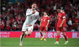  ?? Photograph: Oliver Hardt/Uefa/Getty Images ?? Andreas Christense­n celebrates after he scored Denmark’s third goal from distance.