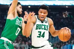  ?? AP Photo/morry Gash ?? Milwaukee Bucks' Giannis Antetokoun­mpo gets past Boston Celtics' Jayson Tatum Saturday during the first half of Game 3 of an NBA basketball Eastern Conference semifinals playoff series in Milwaukee.