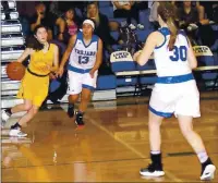  ??  ?? Middletown’s Jessica Pollack drives the baseline as Lower Lake’s Margo Cordova (13) and Shelby Sapeta (30) defend during league action nearly a year ago today.