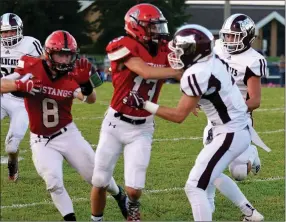  ?? RICK PECK/SPECIAL TO MCDONALD COUNTY PRESS ?? McDonald County wide receiver Reece Cooper (13) throws a downfield block for running back Oakley Roessler during MCHS’s win over Logan-Rogersvill­e on Aug. 31 at MCHS.