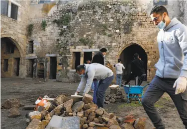  ?? Adel Hana / Associated Press ?? Architects and workers renovate the abandoned alKamalaia School in the old quarter of Gaza City last Sunday. The Mobaderoon, or Initiators, program is seeking to save houses and buildings in the territory.