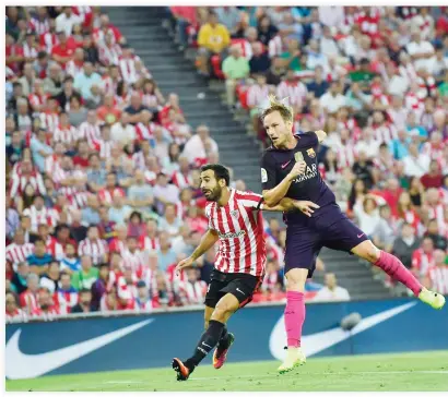  ??  ?? FINDS THE NET: Barcelona's Ivan Rakitic, right, heads the ball to goal beside Athletic Bilbao's Mikel Balenziaga, during the Spanish La Liga match at San Mames stadium, in Bilbao, on Sunday. (AP)