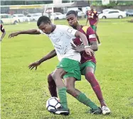  ?? FILE ?? Frome Technical High’s Zico Stone (front) tries to get by Green Island’s Brandon Newman during their ISSA/WATA daCosta Cup match at the Frome Sports Complex on Thursday, October 4.