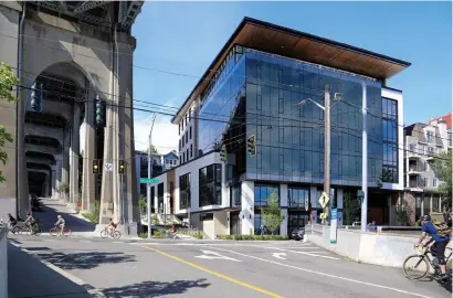  ?? Rachael Meyer/weber Thompson via © The New York Times ?? A photo provided by the architectu­re firm Weber Thompson shows the Watershed building in Seattle. The building, next to the Aurora Bridge, has a slanted roof that collects rainwater.