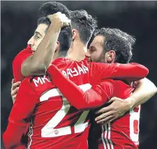  ??  ?? Juan Mata (right) celebrates with team-mates after scoring Manchester United’s first goal against Hull last night.