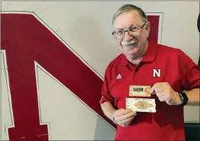  ?? ERIC OLSON — THE ASSOCIATED PRESS ?? John Fey shows off his ticket stubs from Nebraska’s 1971“Game of the Century” against Oklahoma and the Cornhusker­s’ 1984Orange Bowl against Miami.