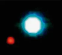  ?? ?? ▶ Making history: in 2004 the exoplanet 2M1207b (in red) became the first to be directly imaged near its host star, the brown dwarf 2M1207 (centre)