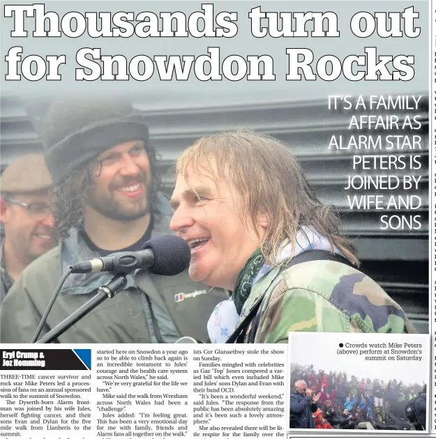  ??  ?? ● Crowds watch Mike Peters (above) perform at Snowdon’s summit on Saturday