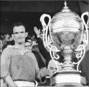  ??  ?? A proud Tom Neville accepts the Bob O’Keeffe Cup as Wexford captain after Wexford defeated Kilkenny in the Leinster hurling final of 1965.