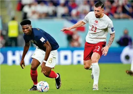  ?? AP ?? Tchouaméni (22) conduce la pelota en el duelo Francia-Dinamarca ante la presencia de Hojbjerg (27).