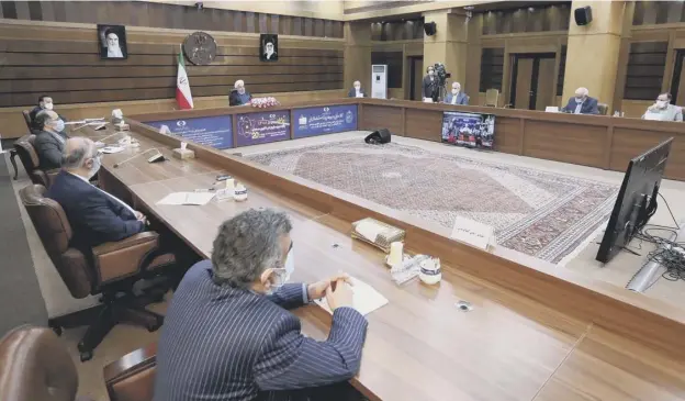  ??  ?? 0 Iranian president Hassan Rouhani (centre) delivers a speech as officials listen, on Iran’s National Nuclear Technology Day, in the capital Tehran