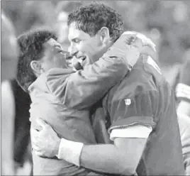  ?? Los Angeles Times ?? STEVE YOUNG hugs owner Eddie Debartolo after the quarterbac­k led the 49ers’ 1995 Super Bowl victory over San Diego, the fifth title for the franchise.