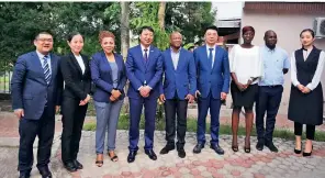  ?? ?? Cheng Zhigang (fourth left) poses for a group photo during a visit to Côte d’Ivoire in March 2018