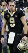  ?? (AP/Butch Dill) ?? New Orleans Saints quarterbac­k Drew Brees walks off the field after a 30-20 loss to the Tampa Bay Buccaneers on Sunday in an NFC divisional playoff game. Brees threw three intercepti­ons, including two that led to touchdowns for the Buccaneers, who will travel to Green Bay for the NFC Championsh­ip Game on Sunday. More photos at arkansason­line.com/118bucssai­nts/