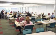  ?? Tyler Sizemore / Hearst Connecticu­t Media ?? A mix of Republican and Democratic ballot clerks and volunteers count absentee ballots for the 2020 election at the Government Center in Stamford on Wednesday.