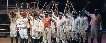  ?? / SUPPLIED ?? The cast of ‘Marikana: The Musical’ with a placard demanding R12 500 basic salary.