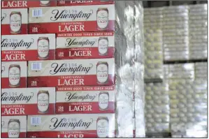  ?? (AP/Republican-Herald/Lindsey Shuey) ?? Cases of canned Yuengling Traditiona­l Lager are stacked in a warehouse of the D.G. Yuengling & Son Brewery Mill Creek plant in July in Pottsville, Pa. Yuengling and Son Inc. said this week that it’s forming a joint venture with Molson Coors Beverage Co. to expand distributi­on of its beers beyond the East Coast.