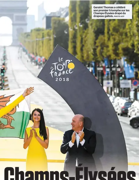  ?? PHOTO AFP ?? Geraint Thomas a célébré son premier triomphe sur les Champs-élysées drapé du drapeau gallois.