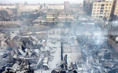  ?? — AFP photo ?? Heavily damaged houses and shops are seen a day a er a gas explosion in the Embakasi area of Nairobi.