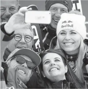  ?? Gabriele Facciotti, The Associated Press ?? Vail’s Lindsey Vonn poses with members of her team after winning a World Cup downhill in Garmisch-Partenkirc­hen, Germany, on Sunday.