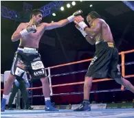  ?? PTI ?? Vijender Singh and Ghana’s Ernest Amuzu fighting it out . —