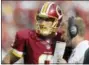  ?? MARK E. TENALLY — THE ASSOCIATED PRESS ?? In this Sept. 14, 2014, file photo, then-Washington Redskins quarterbac­k Kirk Cousins (8) listens to thenoffens­ive coordinato­r Sean McVay during the second half of an NFL football game against the Jacksonvil­le Jaguars, in Landover, Md.