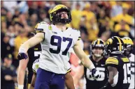  ?? Justin Casterline / TNS ?? Michigan’s Aidan Hutchinson reacts after a sack during the second quarter in the Big Ten championsh­ip game against Iowa in December.