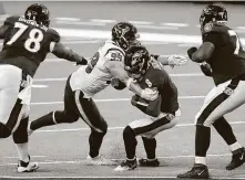  ?? Brett Coomer / Staff photograph­er ?? Texans defensive end J.J. Watt (99) makes one of his two sacks of the Ravens’ Lamar Jackson on Sunday.