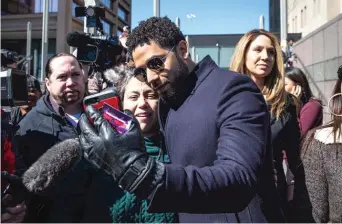  ??  ?? Jussie Smollett takes a selfie with a supporter as he leaves the Leighton Criminal Courthouse in March of 2019.