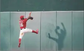  ?? Alex Brandon / Associated Press ?? Washington center fielder Victor Robles jumps to the wall but can't catch a two-run home run hit by Atlanta’s Pablo Sandoval.