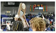  ?? (Pine Bluff Commercial/I.C. Murrell) ?? The Zebras hoist the 5A state championsh­ip trophy with the final score 67-51 in the background.