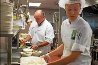  ?? SUBMITTED PHOTO ?? Valley Forge Tourism and Convention Board President and CEO Mike Bowman, center, puts the finishing touches on the first course in a three-course meal served to more than 100 Manna on Main Street guests Sept. 26. The event fell during the tourism...