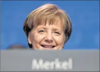  ?? AP PHOTO ?? German Chancellor and party chairwoman Angela Merkel smiles at the party convention of the Christian Democratic Union CDU in Berlin. The members of the Social Democratic party voted for a coalition agreement with Merkel’s party paving the way for...
