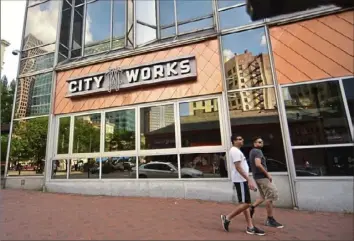  ?? Lucy Schaly/Post-Gazette ?? Pedestrian­s walk past the new City Works Restaurant on Friday in Market Square.