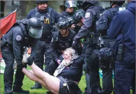  ?? THE ASSOCIATED PRESS ?? Police remove a protester on the University of Pennsylvan­ia campus, in Philadelph­ia, on Friday.