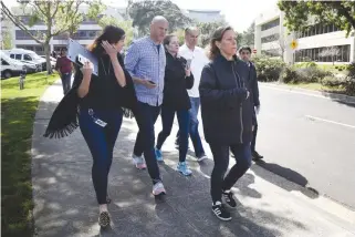  ??  ?? AN APRIL 3 photo shows YouTube Chief Executive Officer Susan Wojcicki (right) leading staff near the company’s headquarte­rs following an active shooter situation in San Bruno, California.