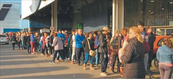  ??  ?? COLAS DE MIERCOLES. Larga fila en el ingreso de un supermerca­do en Avellaneda. El reintegro del 50% en compras de hasta $ 3000 pesos por un banco público activó compras mientras el consumo no crece.